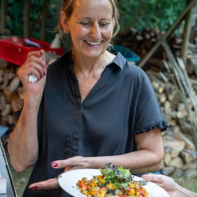 Anja, Event- und Projektleitung bei tonis EATERY, serviert einen Teller beim Event